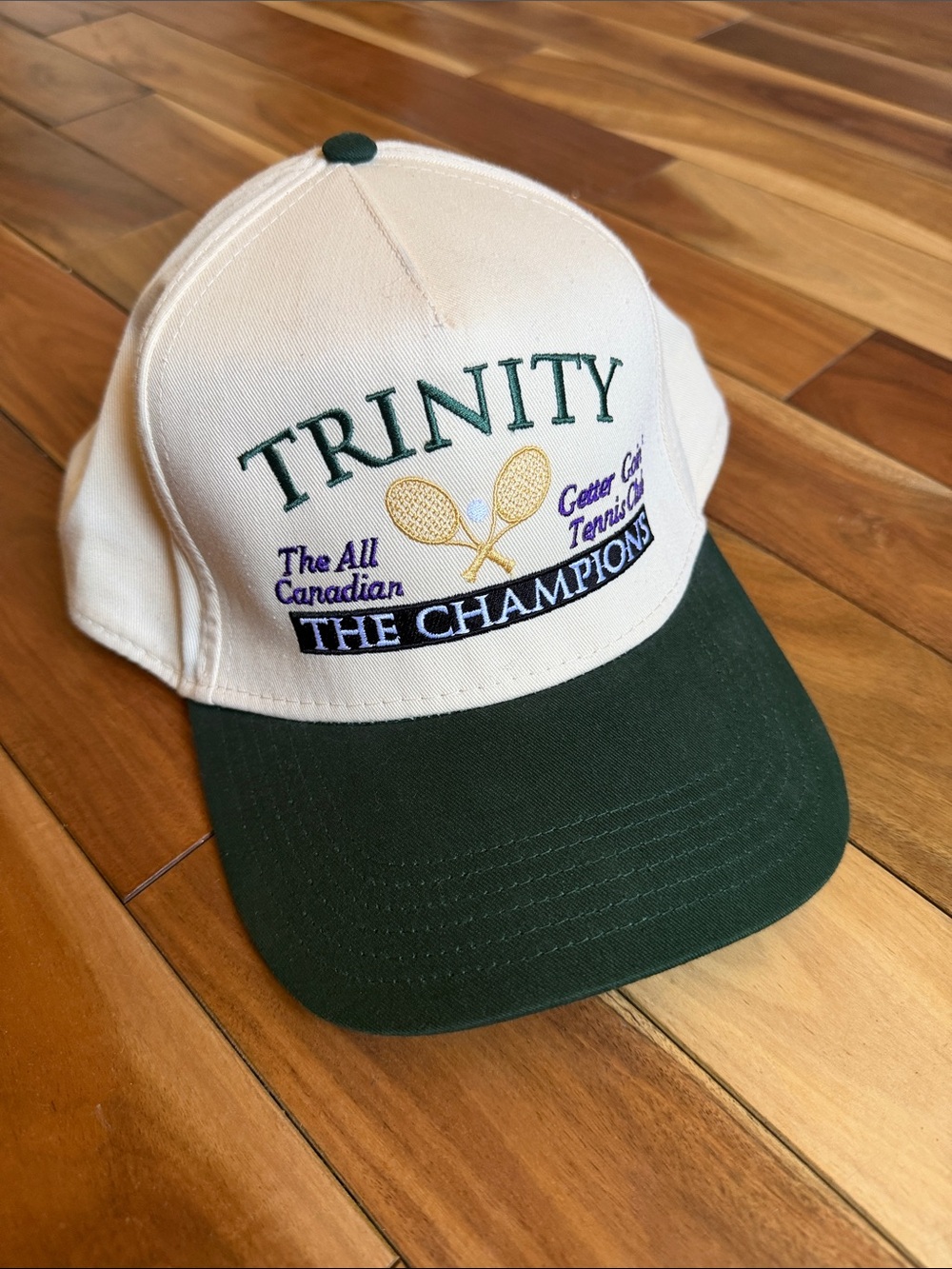 Trinity White Cap with Dark Green Visor and Gold Tennis Motif
